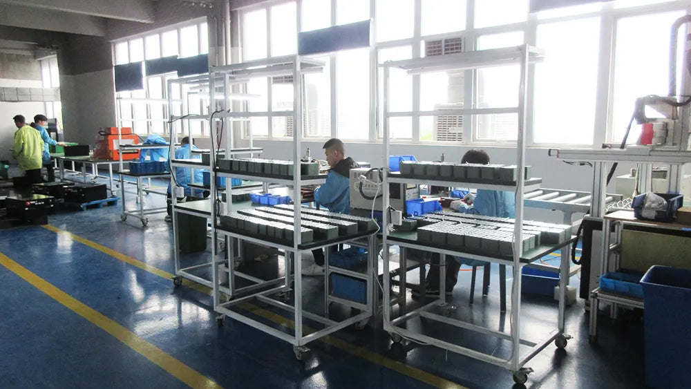 Workers assembling electric golf carts on the final assembly production line